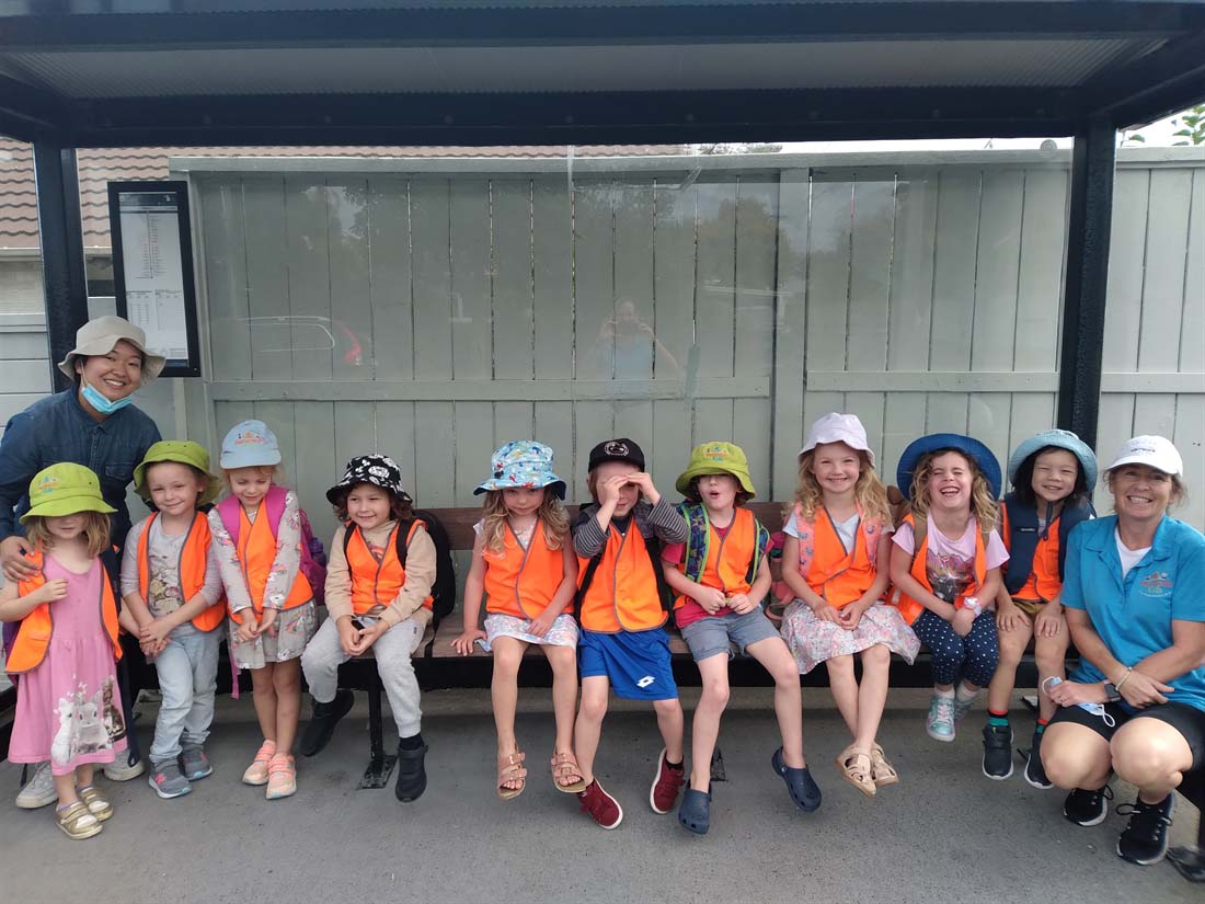 Kids at a bus stop Kids at a bus stop